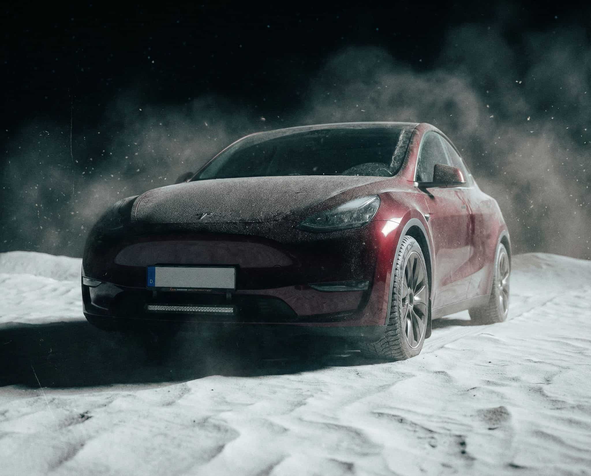 Tesla Model Y with Luxtar Twilight on a wet road